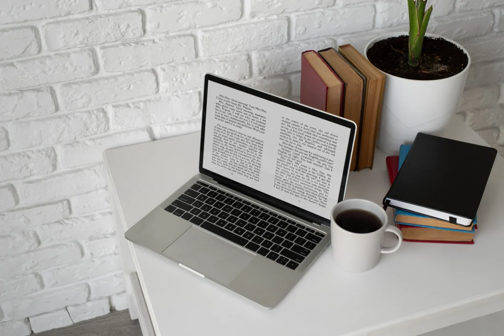 laptop with e-book and coffee on white desk