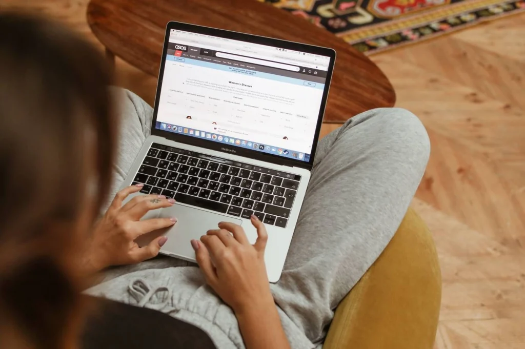 Person researching website citation format on a laptop